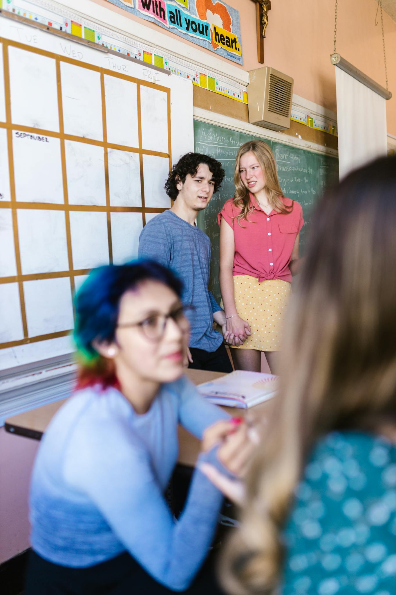 A diverse group of students collaborate in a lively classroom environment.